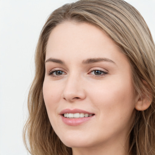 Joyful white young-adult female with long  brown hair and blue eyes