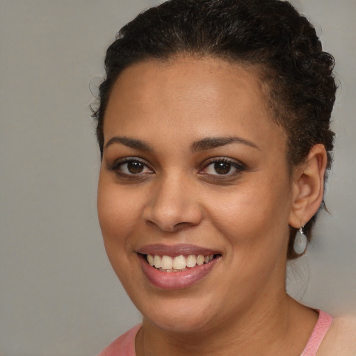 Joyful black young-adult female with medium  brown hair and brown eyes