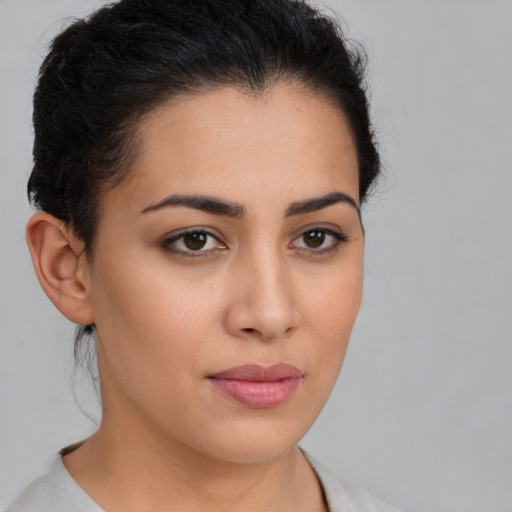 Joyful latino young-adult female with short  brown hair and brown eyes