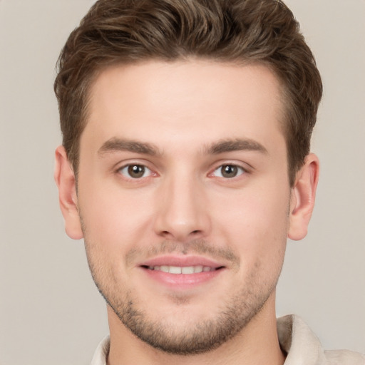 Joyful white young-adult male with short  brown hair and grey eyes