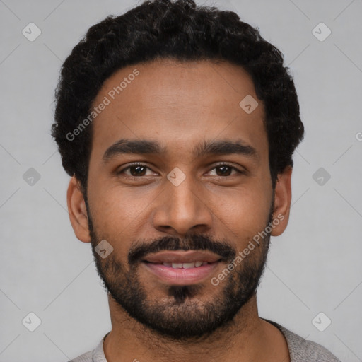 Joyful black young-adult male with short  black hair and brown eyes