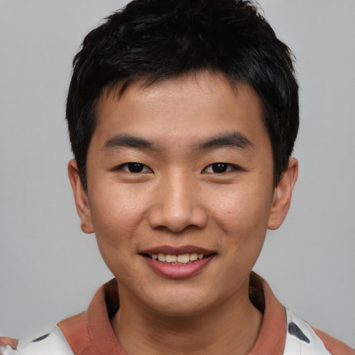 Joyful asian young-adult male with short  black hair and brown eyes