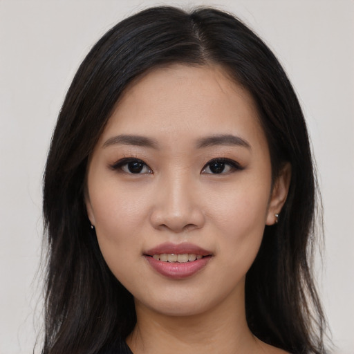 Joyful asian young-adult female with long  black hair and brown eyes