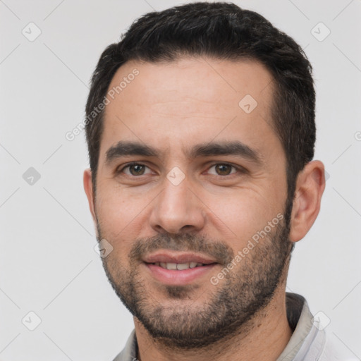 Joyful white young-adult male with short  black hair and brown eyes