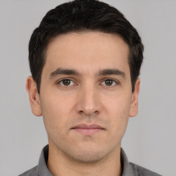 Neutral white young-adult male with short  black hair and brown eyes