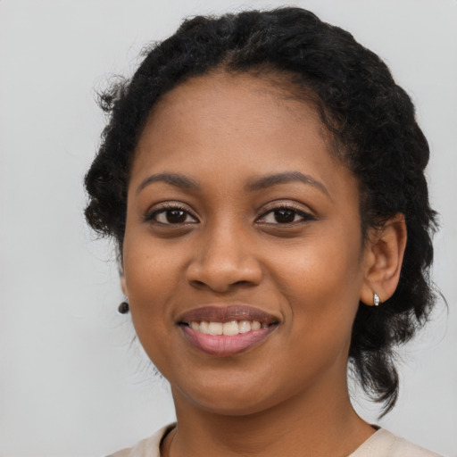 Joyful black young-adult female with medium  black hair and brown eyes