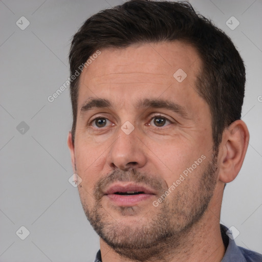 Joyful white adult male with short  brown hair and brown eyes