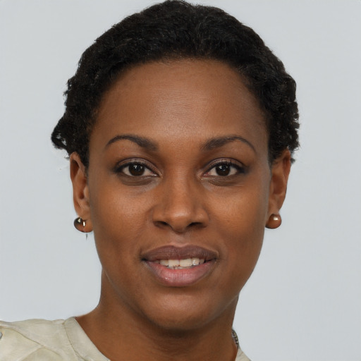 Joyful black young-adult female with short  brown hair and brown eyes