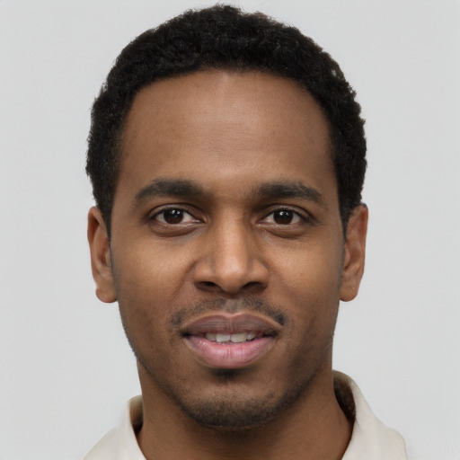 Joyful black young-adult male with short  black hair and brown eyes