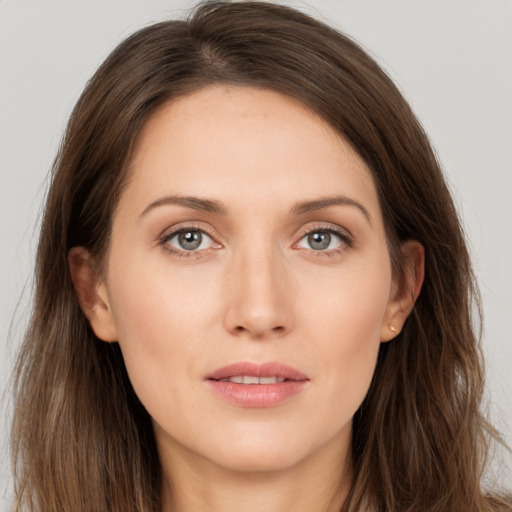 Joyful white young-adult female with long  brown hair and grey eyes