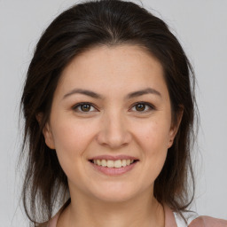 Joyful white young-adult female with medium  brown hair and brown eyes