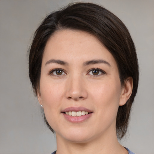 Joyful white young-adult female with medium  brown hair and brown eyes