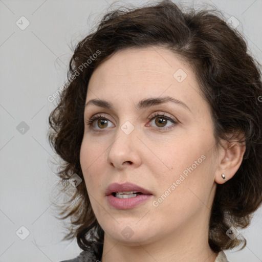 Joyful white young-adult female with medium  brown hair and green eyes