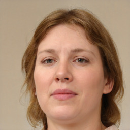 Joyful white young-adult female with medium  brown hair and blue eyes