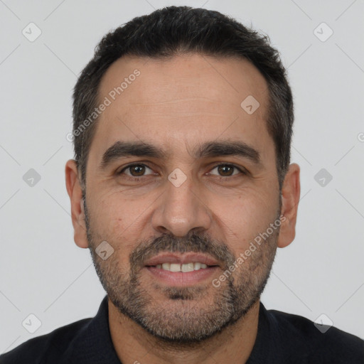 Joyful white adult male with short  black hair and brown eyes