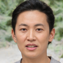 Joyful asian young-adult male with short  brown hair and brown eyes