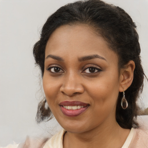 Joyful black young-adult female with medium  brown hair and brown eyes