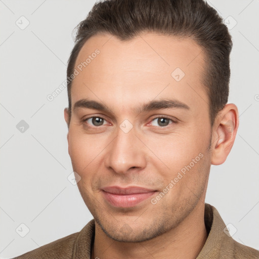 Joyful white young-adult male with short  brown hair and brown eyes