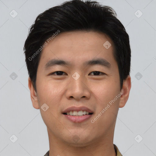 Joyful asian young-adult male with short  black hair and brown eyes