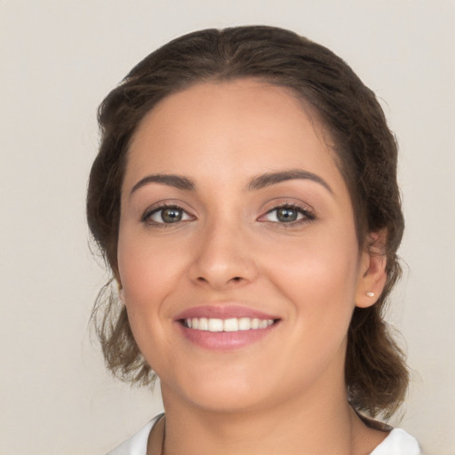 Joyful white young-adult female with medium  brown hair and brown eyes