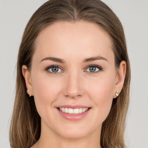 Joyful white young-adult female with long  brown hair and grey eyes