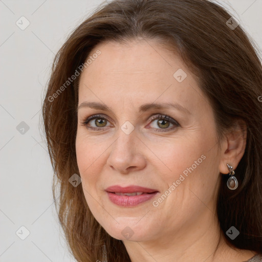 Joyful white adult female with long  brown hair and grey eyes