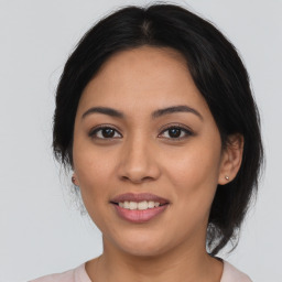 Joyful latino young-adult female with medium  brown hair and brown eyes