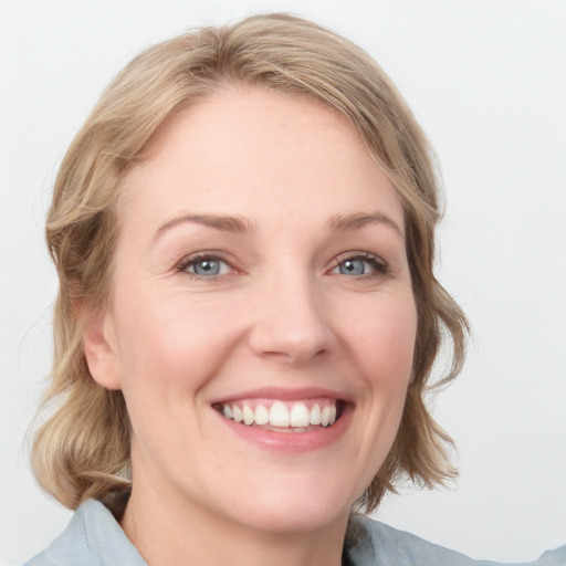 Joyful white young-adult female with medium  brown hair and blue eyes