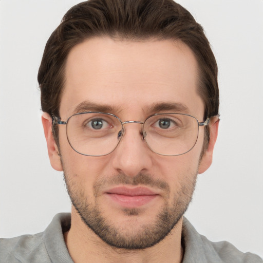 Joyful white adult male with short  brown hair and grey eyes