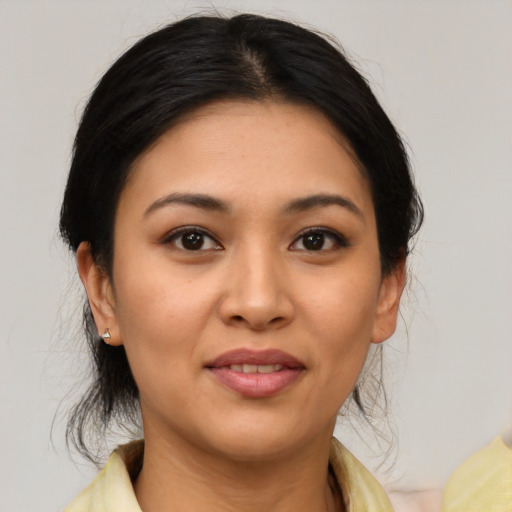 Joyful asian young-adult female with medium  brown hair and brown eyes