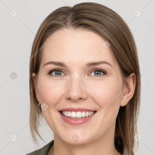 Joyful white young-adult female with medium  brown hair and grey eyes