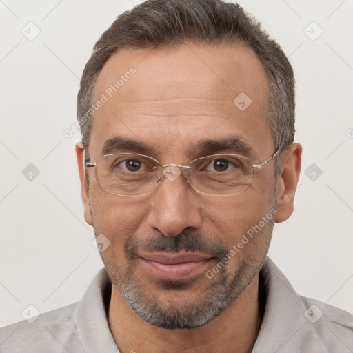 Joyful white adult male with short  brown hair and brown eyes