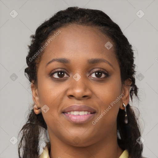 Joyful black young-adult female with long  black hair and brown eyes