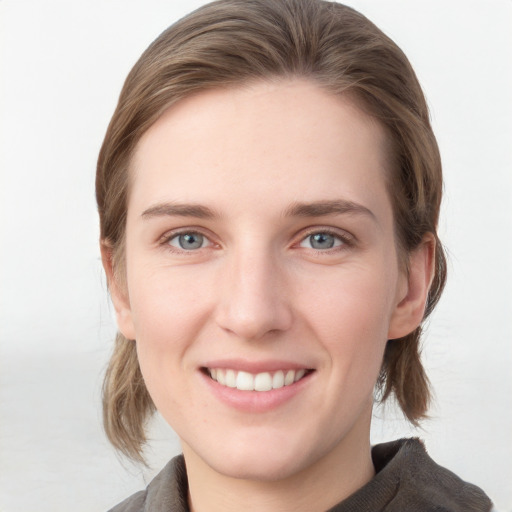 Joyful white young-adult female with medium  brown hair and blue eyes