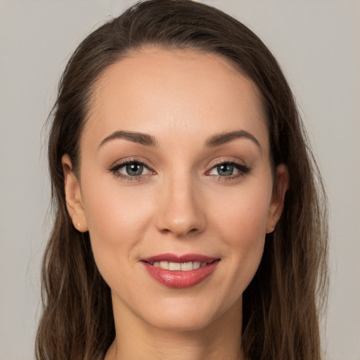 Joyful white young-adult female with long  brown hair and brown eyes