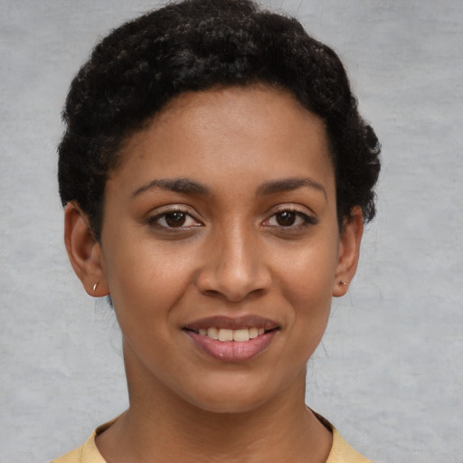 Joyful latino young-adult female with short  brown hair and brown eyes