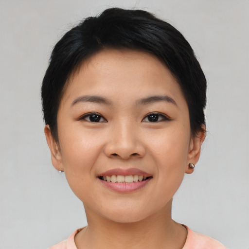 Joyful asian young-adult female with short  black hair and brown eyes
