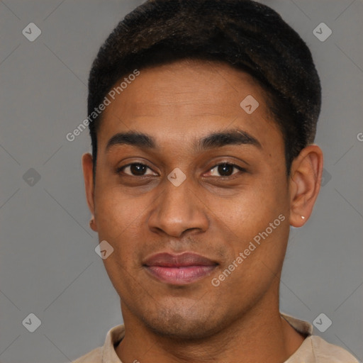 Joyful black young-adult male with short  brown hair and brown eyes