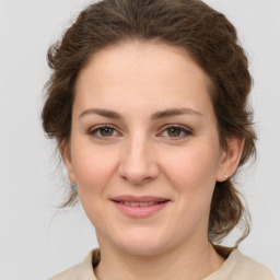 Joyful white young-adult female with medium  brown hair and green eyes