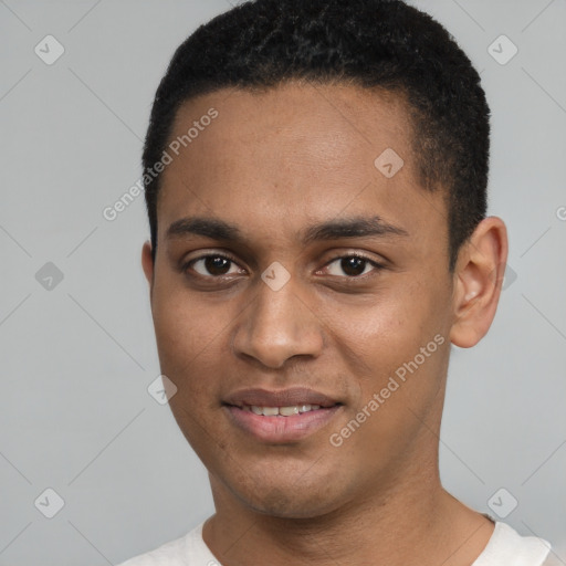 Joyful black young-adult male with short  black hair and brown eyes