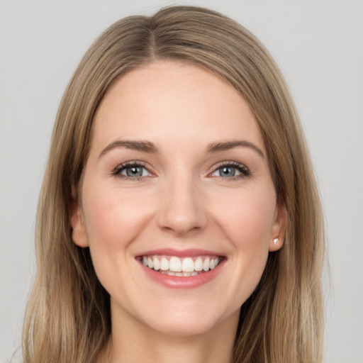 Joyful white young-adult female with long  brown hair and grey eyes