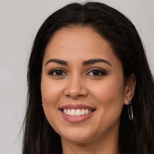 Joyful latino young-adult female with long  brown hair and brown eyes