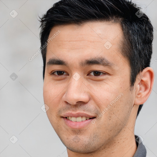 Joyful white young-adult male with short  black hair and brown eyes