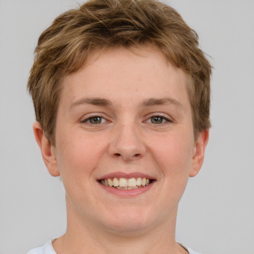 Joyful white young-adult female with short  brown hair and grey eyes