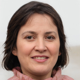 Joyful white adult female with medium  brown hair and brown eyes