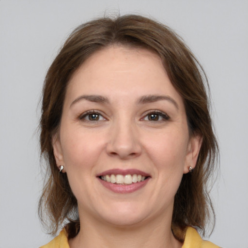 Joyful white young-adult female with medium  brown hair and brown eyes