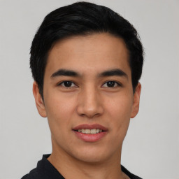 Joyful asian young-adult male with short  black hair and brown eyes