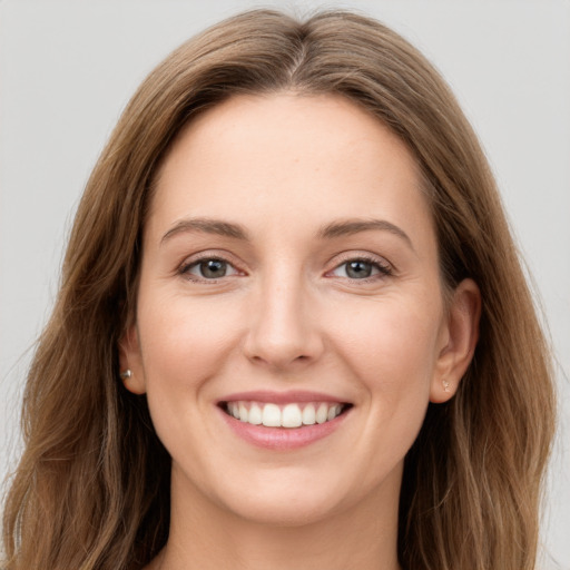 Joyful white young-adult female with long  brown hair and grey eyes