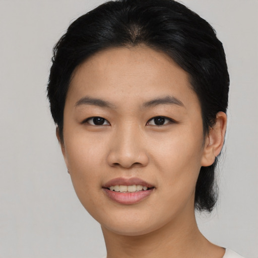 Joyful asian young-adult female with short  black hair and brown eyes
