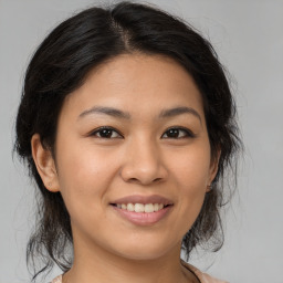 Joyful asian young-adult female with medium  brown hair and brown eyes